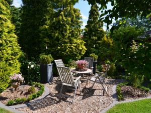 two chairs and a table in a garden at Ferienwohnung in Madfeld nahe Wald in Madfeld
