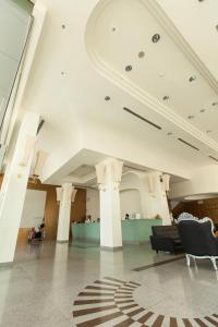 a lobby with chairs and a table in a building at New Season Hotel in Hat Yai