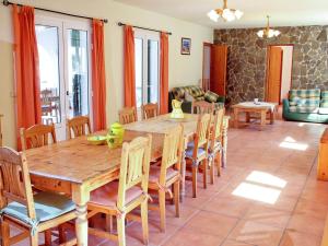 a dining room with a wooden table and chairs at Belvilla by OYO Canyar Enzell in Es Mercadal