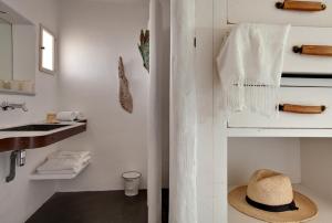 a hat is sitting on the floor in a bathroom at Lodge Sainte Helene in Saintes-Maries-de-la-Mer
