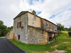 an old stone building on the side of a road at Heavenly holiday home with pool in Villefranche-du-Périgord