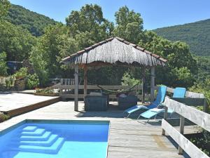 a swimming pool with chairs and a gazebo at Charming villa with private pool in Prémian