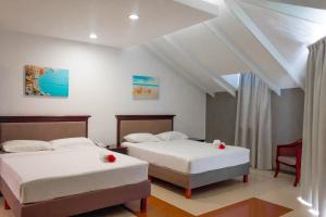 Кровать или кровати в номере Curacao Suites Hotel