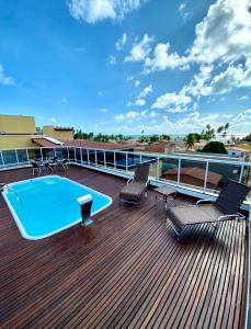 a deck with a swimming pool on top of a building at Pousada Morada do Sol in Maragogi