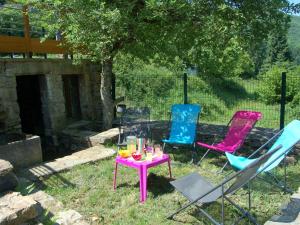 a group of chairs and a table with drinks on it at Graceful Holiday Home in Montclar with bubble bath in Montclar