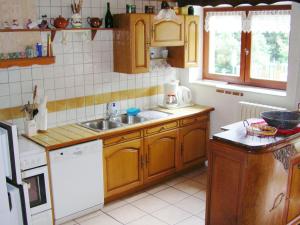 a small kitchen with wooden cabinets and a sink at Charming Chalet in Champagny en Vanoise near Ski Area in Le Villard