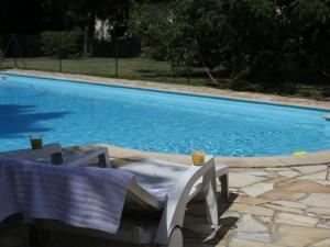 a table and chairs next to a swimming pool at Peaceful holiday home near Quend with pool in Quend
