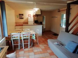 a kitchen and dining room with a table and chairs at Peaceful holiday home near Quend with pool in Quend