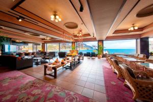a restaurant with a view of the ocean at Inatori Akao Hotel in Higashiizu