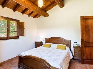 sypialnia z drewnianym łóżkiem i oknem w obiekcie Holiday Home in Umbria with Pool and Views w mieście San Secondo