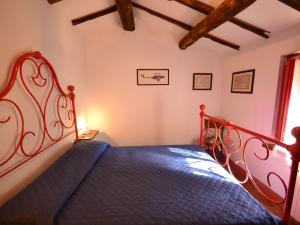 a bedroom with a bed with a metal head board at Belvilla by OYO Birilli in San Marcello Pistoiese