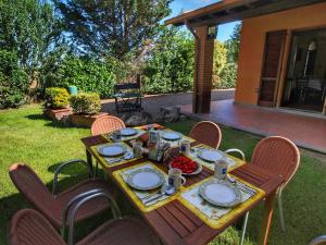 una mesa de madera con platos de comida. en Belvilla by OYO Attractive mansion with pool en Valiano