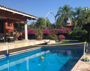 a swimming pool with a yellow caution tape around it at Un oasis de tranquilidad y diversión familiar in Yautepec +20 photos