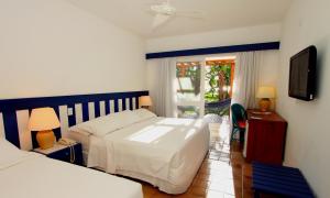 Postel nebo postele na pokoji v ubytování Arraial D'ajuda Eco Resort