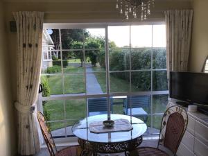 um quarto com uma mesa e uma grande janela em Mohaonui Farmstay em Otorohanga