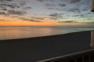 a view of the ocean at sunset from a balcony at Admiralty House 1705S in Marco Island
