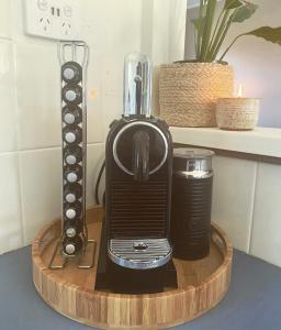 a black toaster sitting on a wooden cutting board at Honey at KI in Kingscote