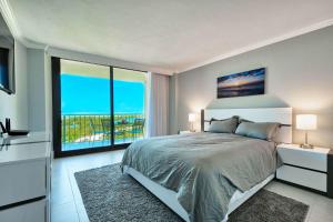 a bedroom with a large bed and a large window at Sst3 #701 in Marco Island