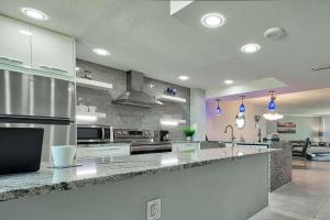 a large kitchen with stainless steel appliances and a counter at Sst3 #701 in Marco Island