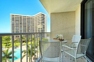 a balcony with a table and chairs and a building at Sst3 #701 in Marco Island