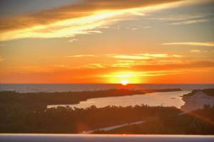 a sunset over the ocean with the sun setting at Sst3 #701 in Marco Island