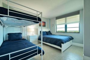 a bedroom with two bunk beds and a window at SSt3 #701 in Marco Island +24 photos