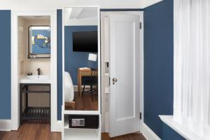 a bathroom with a white door and a sink at voco The Franklin New York by IHG in New York +64 photos