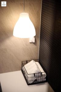 a bathroom with a light and a bed in a shower at Londoner Hotel Gwangan in Busan