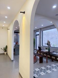 a living room with a table and a large window at Lacasa Homestay in Hue