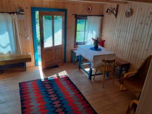 a living room with a table and a room with a door at Small Apartment in Breb s Cosy Barn in Breb