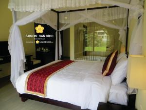 מיטה או מיטות בחדר ב-Sài Gòn - Bản Giốc Resort