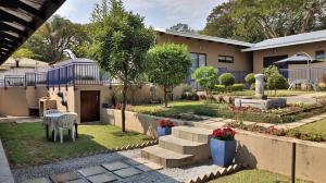 a house with a garden in front of it at Guest House Mamma Mia in Nelspruit