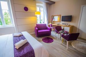 a bedroom with a bed and a table and chairs at Peninsula Luxury Rooms in Zadar