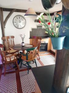 a kitchen with a table and chairs and a clock at Cozy apartment in Galway 60 m² city view in Galway