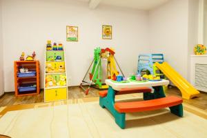 a play room with a table and play equipment at Sanatoriy Elektra in Tal'tsy