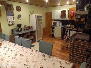 a kitchen and dining room with a table and chairs at Paepealse Guesthouse in Kullamaa