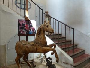 a statue of a horse on a stair case at Château d'Ortaffa in Ortaffa