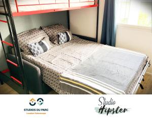 a bedroom with a bunk bed with pillows on it at Studios du Parc apparts Hôtel - Futuroscope in Chasseneuil-du-Poitou