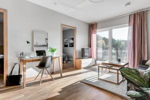 a living room with a desk and a couch at Apartments Mölndal in Gothenburg