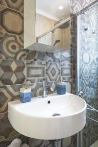 a bathroom with a white sink and a mirror at Casa Vacanza Noban - CaseSicule in Ispica