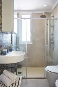 a bathroom with a sink and a shower at Casa Vacanza Noban - CaseSicule in Ispica +13 photos