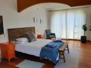 a bedroom with a bed and a table and a chair at Japie's Yard Self-Catering in Swakopmund