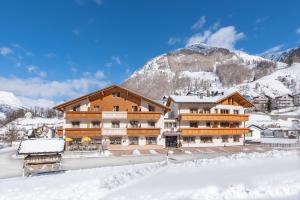 a chalet in the mountains in the snow at Hotel Theiner in Curon Venosta