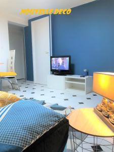 a room with a bed and a tv and a table at L Appart Eurexpo & Groupama Stadium 10' in Genas