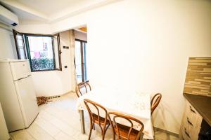 a kitchen with a table and chairs and a refrigerator at Casa di Matty& Lory in Sanremo +13 photos