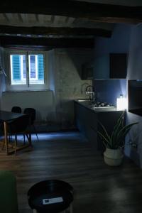 a dark room with a kitchen and a table at LuccaStay 18 in Lucca