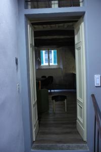 a hallway leading to a room with a window and a chair at LuccaStay 18 in Lucca