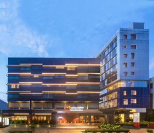 a tall building with lights on in front of it at Swiss-Belinn Wahid Hasyim in Jakarta