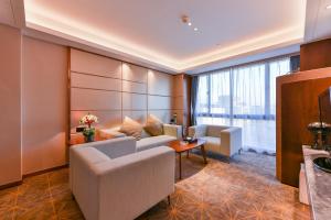 a hotel room with a couch and a table at Guilin Plaza Hotel in Guilin