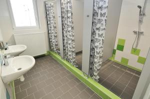 a bathroom with a sink and a shower at Hostel Tereza Břeclav in Břeclav +8 photos